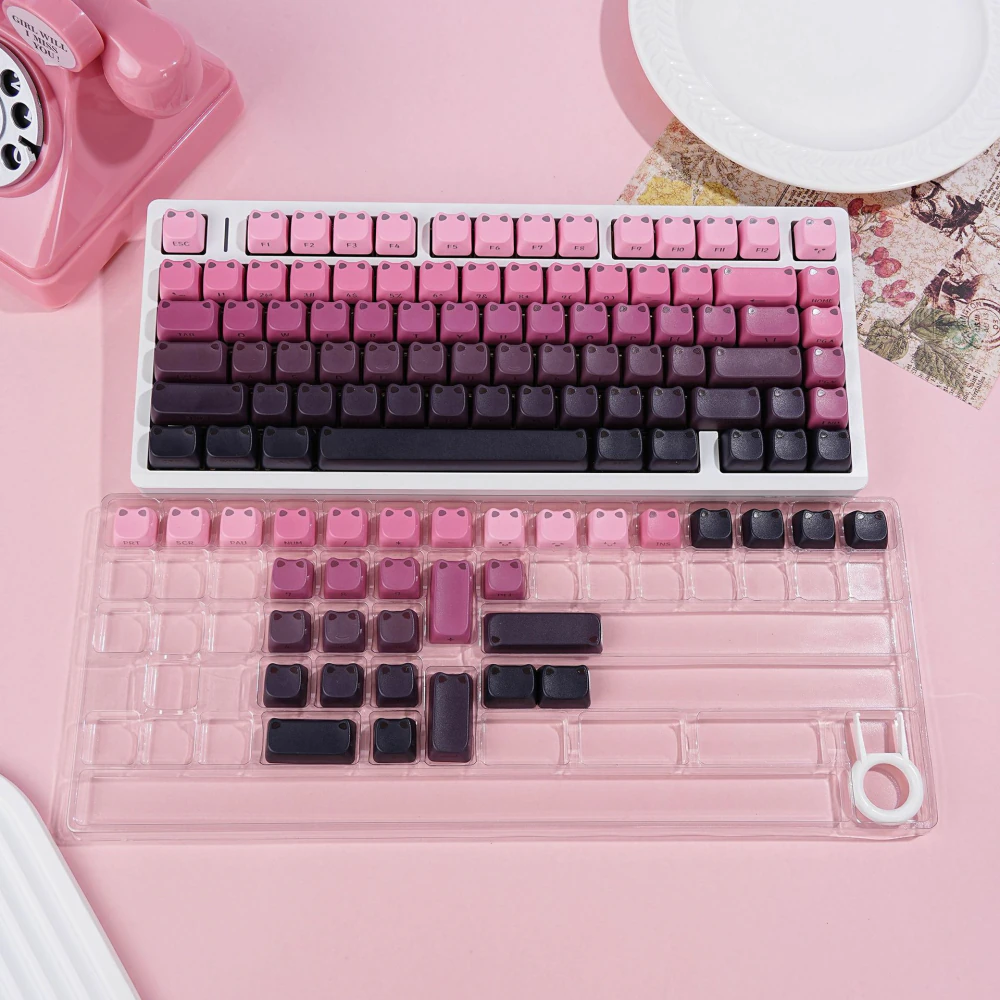 Full keyboard with pink-to-black gradient cat-ear keycaps on a pink background