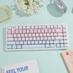 Pink-blue gradient keycaps installed on a white mechanical keyboard