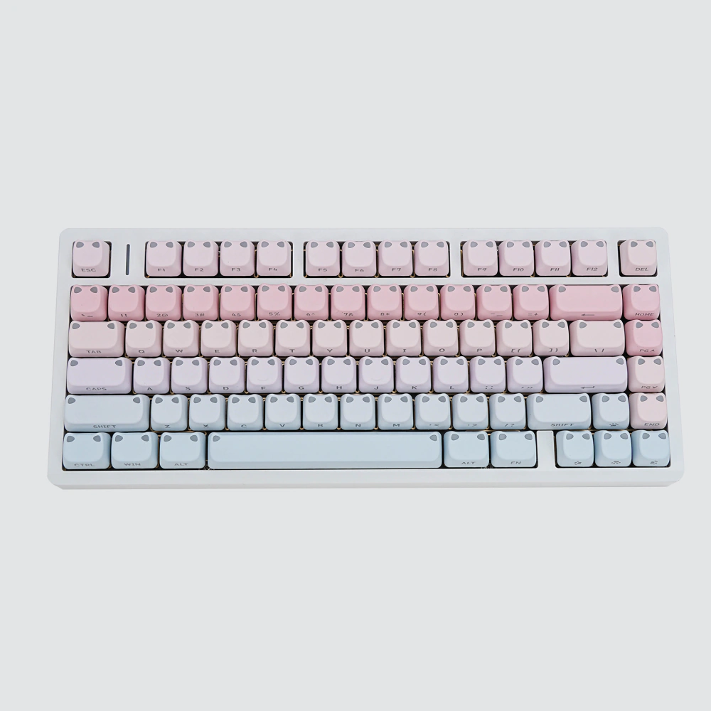 Pink-blue gradient keycaps arranged as a complete set on a white background