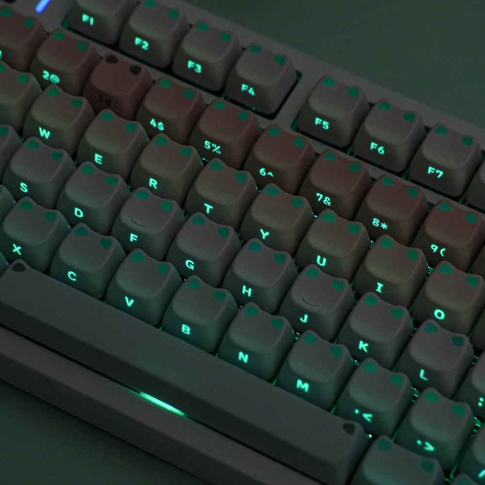Close-up of RGB-lit legends on pink-blue gradient keycaps