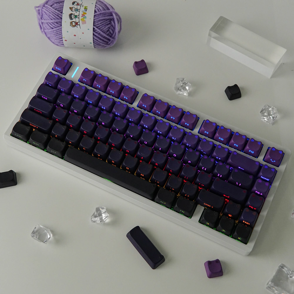 Backlit white keyboard with purple-black gradient keycaps and colorful light between rows