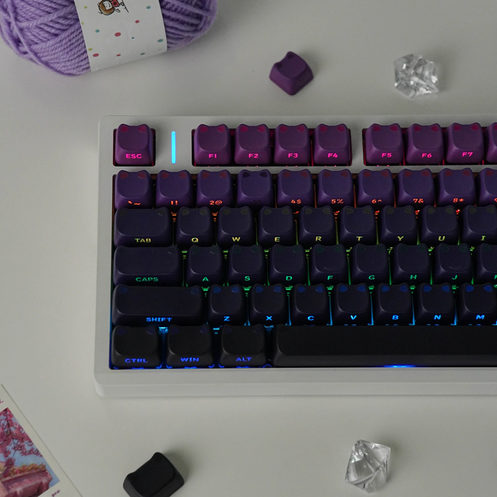 Front view of purple upper rows transitioning to dark purple and black keycaps
