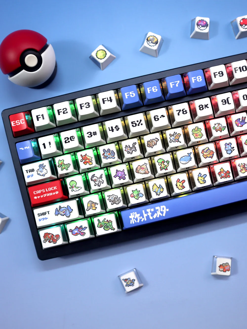 Angled black keyboard with white pixel keycaps, red and blue accents, and loose keycaps.