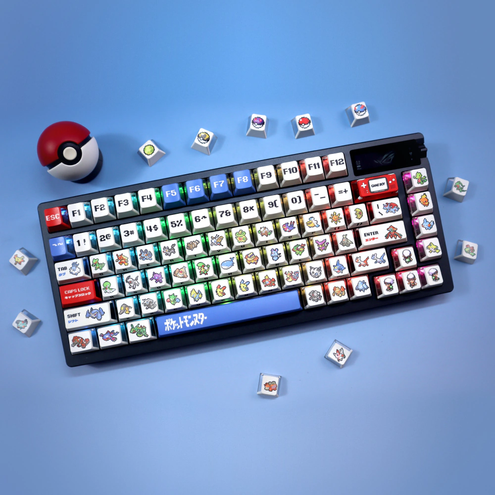 Black keyboard with white pixel keycaps, red and blue accents, and loose novelty keycaps on blue.