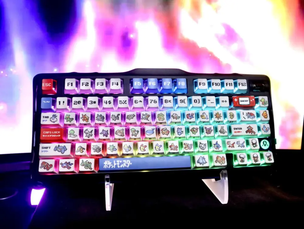 Front view of white pixel keycaps with red and blue accents lit by multicolor keyboard lighting.