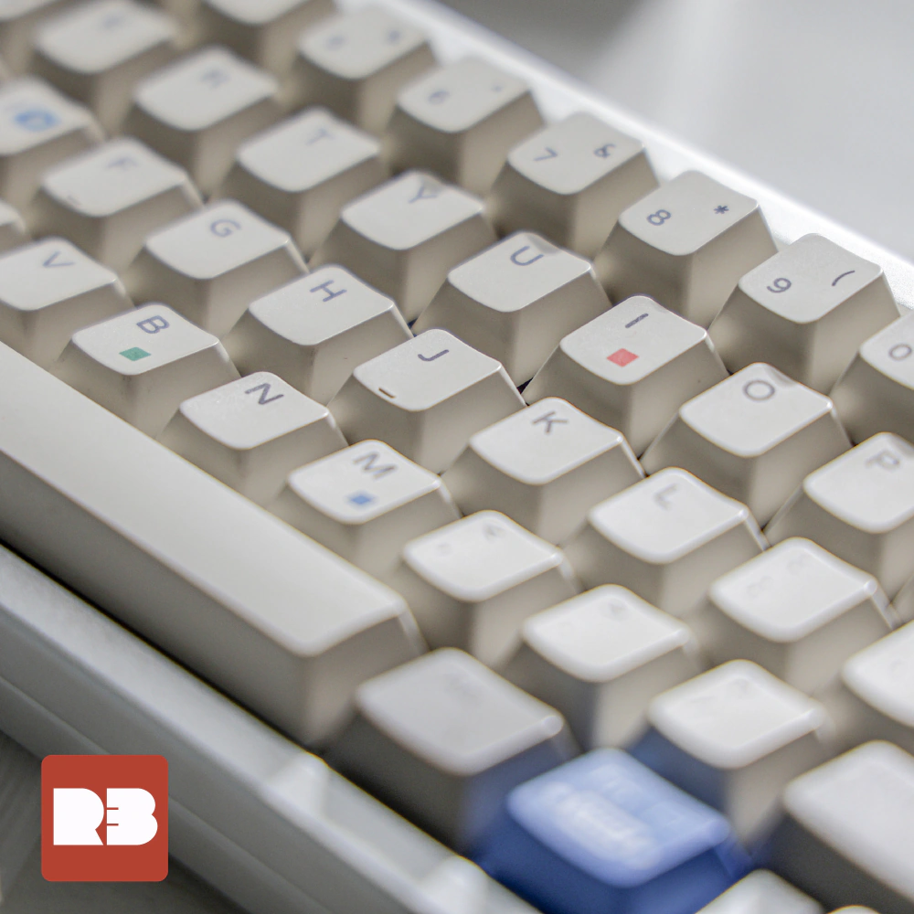 Rows of white keycaps with letter legends and colored square accents, with the lower keys in focus.