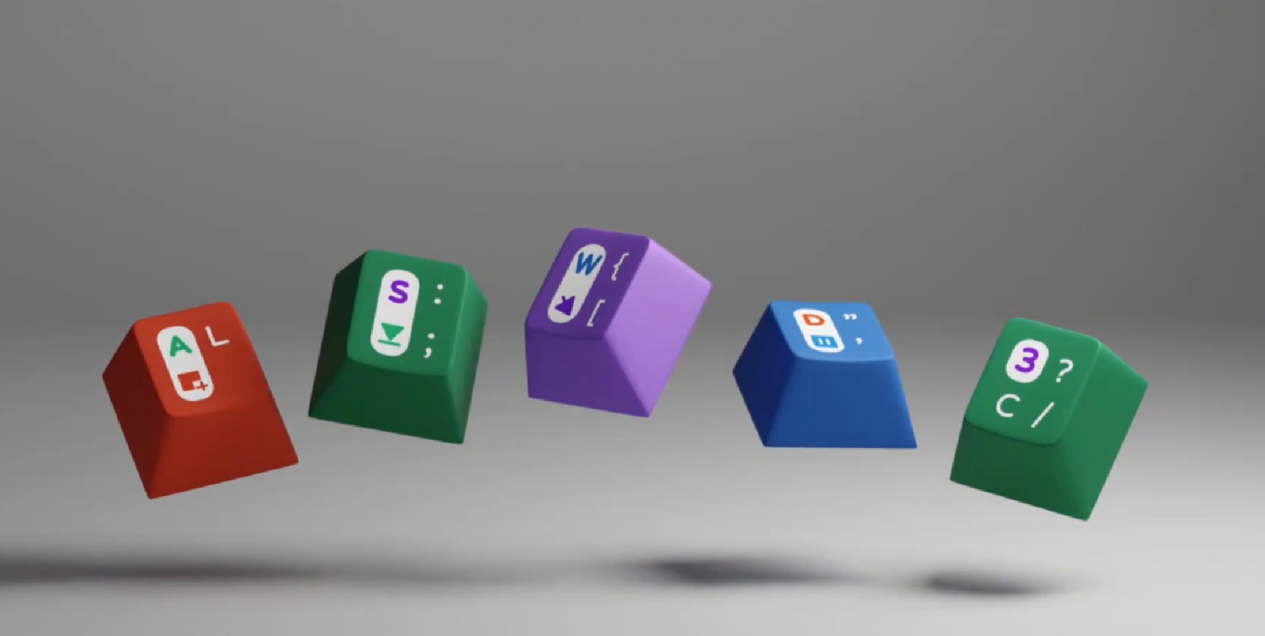 Five separate red, green, purple, and blue novelty keycaps on a plain gray background.
