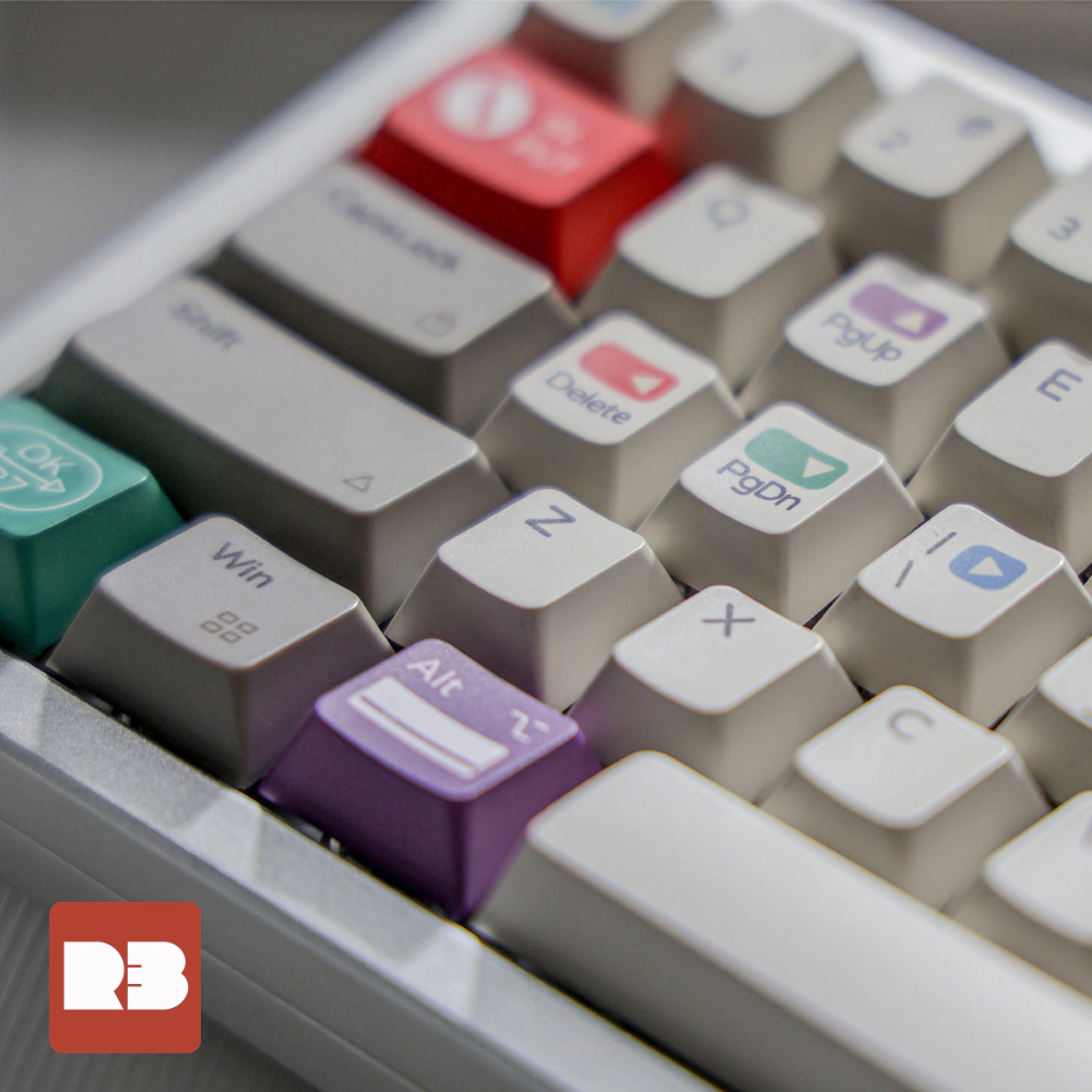 Close-up of gray keys with red Delete, purple PgUp, green PgDn, and teal OK legends.