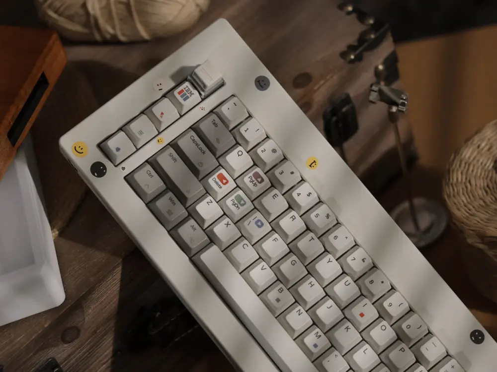 White and gray keyboard seen from above, with colored legends and round novelty keys around the case.