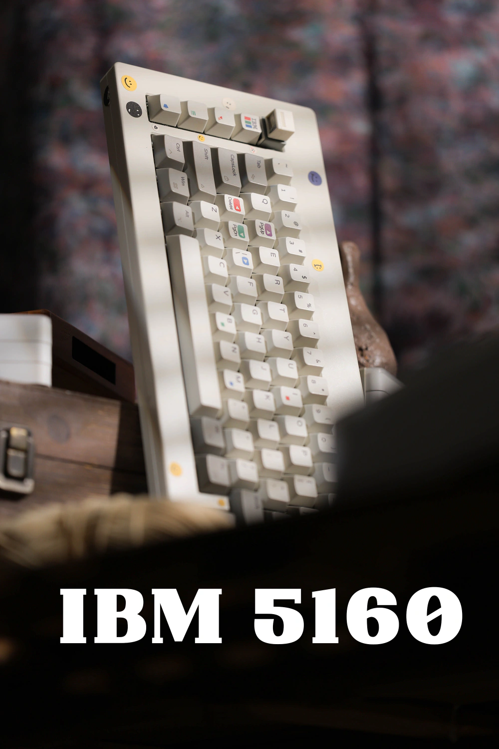 White and gray keyboard angled upright on a wooden stand, with large IBM 5160 lettering below.