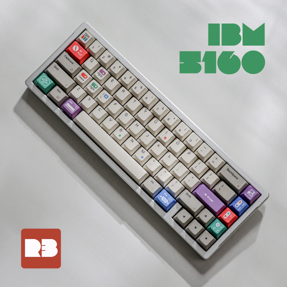 Top-down view of white and gray keycaps with colorful accent keys beside IBM 5160 lettering.