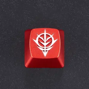 Red Zeon emblem artisan keycap shown from above on a dark textured surface.