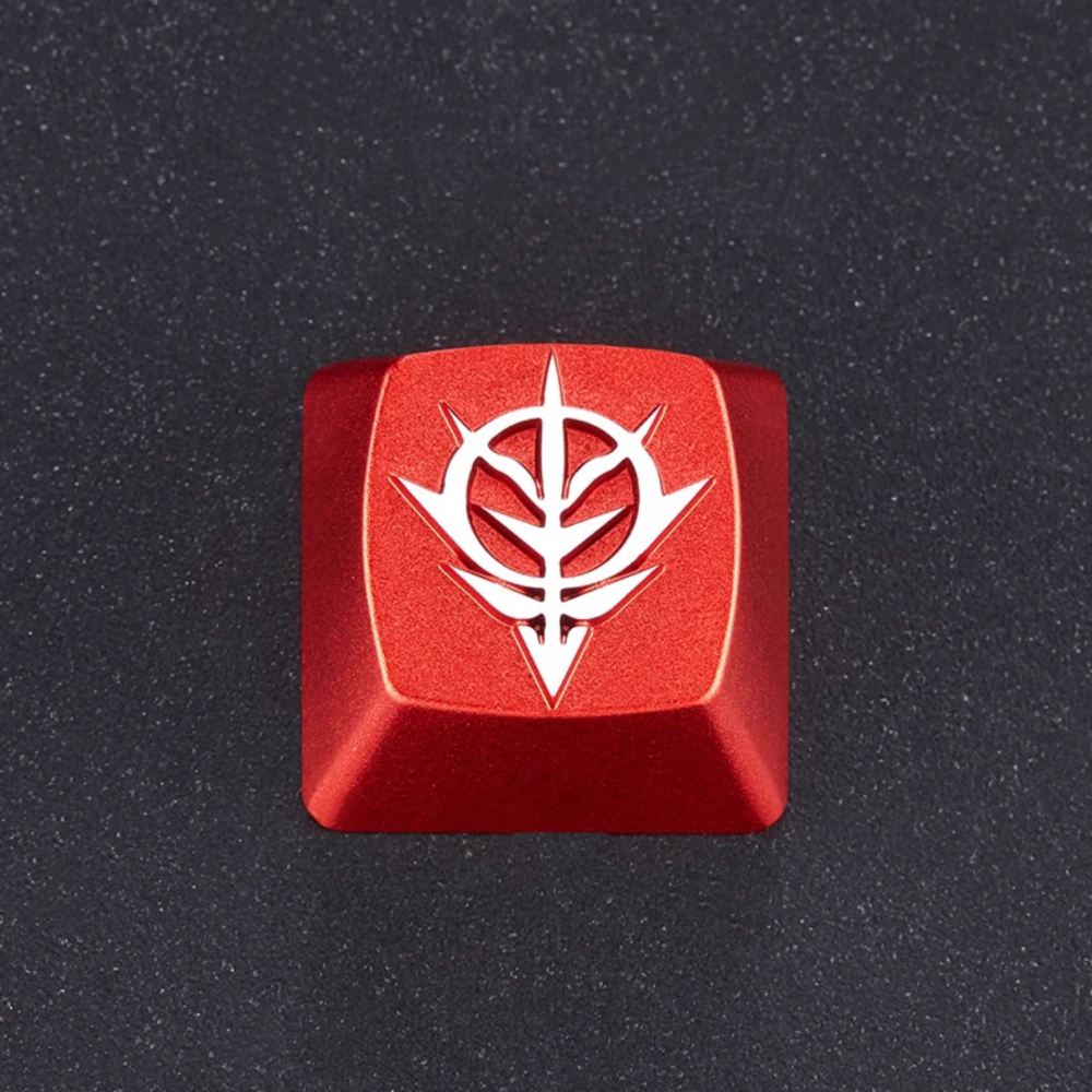 Red Zeon emblem artisan keycap shown from above on a dark textured surface.