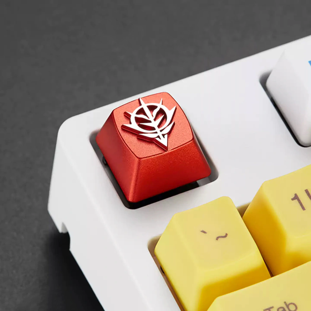 Red Zeon emblem artisan keycap installed at an angle on a white mechanical keyboard.