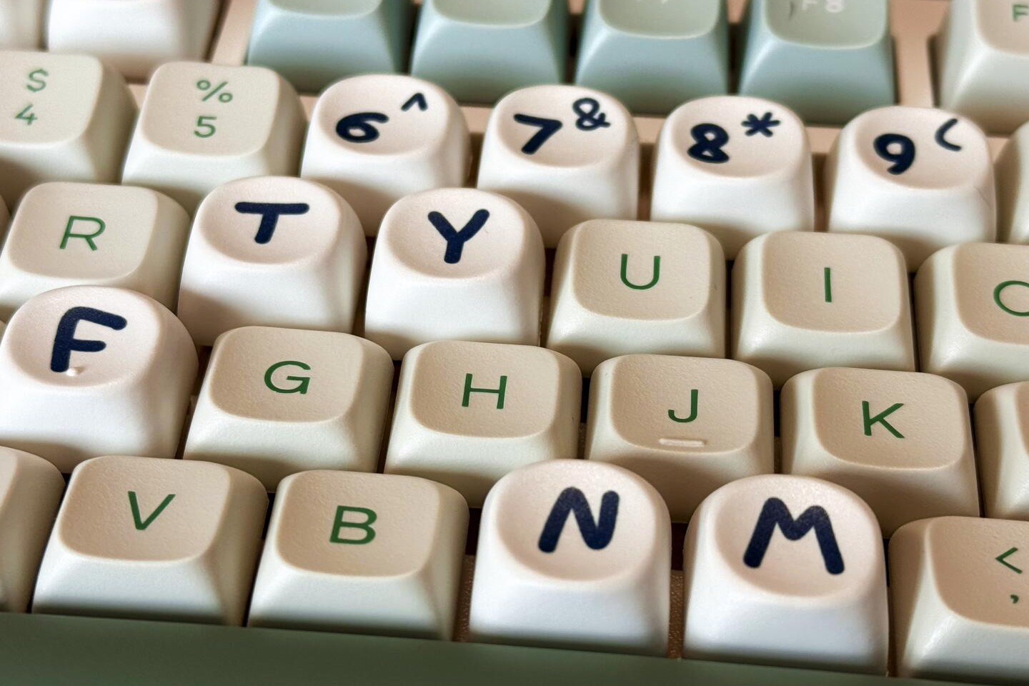 KeysFusion — Custom Keycaps, Artisan Keycaps & Mechanical Keyboard Accessories Close-up of white keycaps with varied shapes and heights on a keyboard