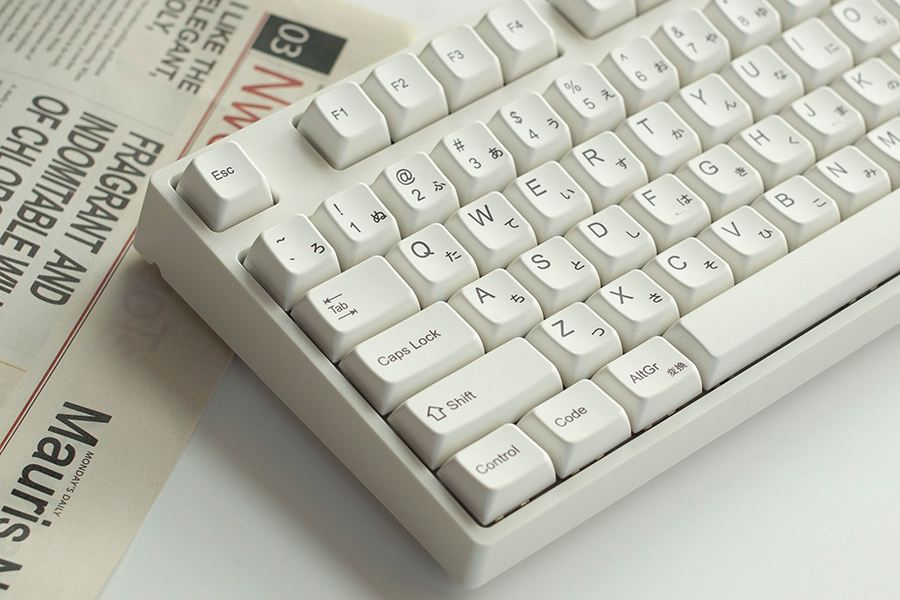 White keycaps with broad tops on a compact keyboard