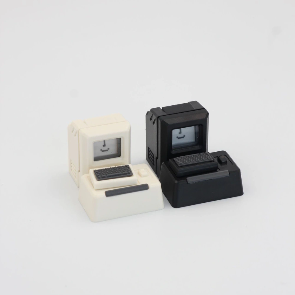 Front view of two Macintosh-style computer caps, one black and one cream, on a white background.