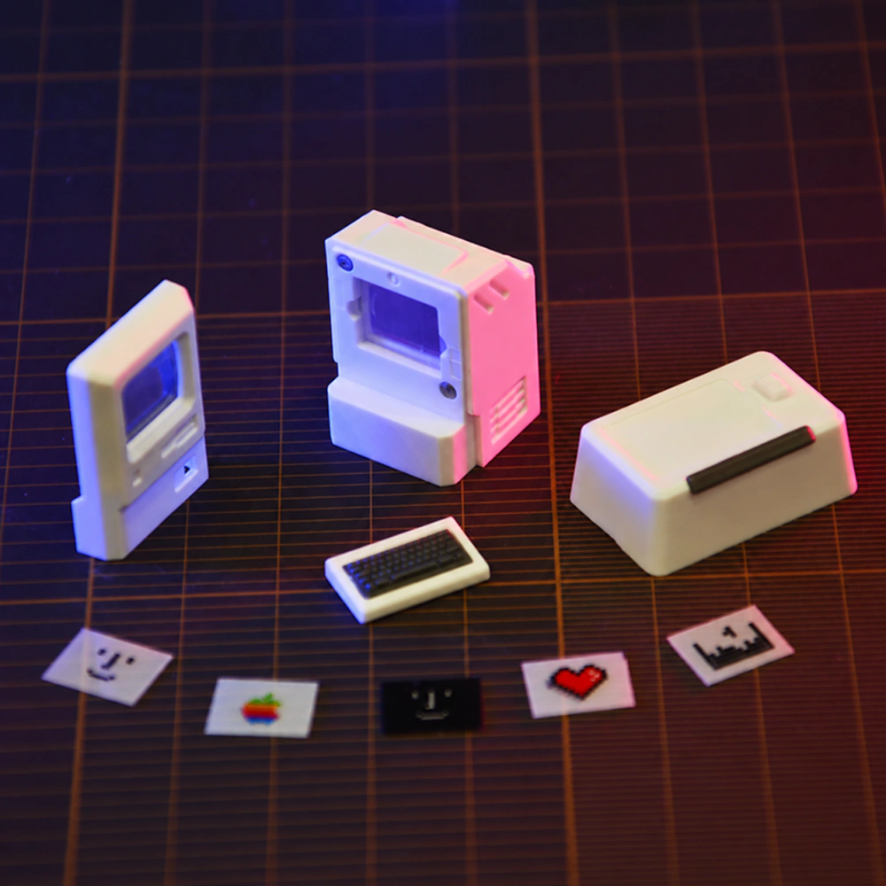 Two miniature computer caps, one small keyboard piece, and five screen cards arranged together.
