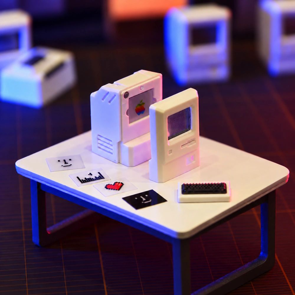 Open white computer-shaped cap with its front panel removed, loose picture cards, and a mini keyboard nearby.